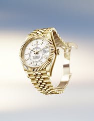A gold Rolex sky-dweller watch